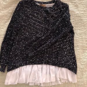 Black and white speckled knit sweater with ruffles